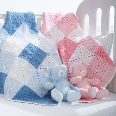 a crocheted blanket and teddy bear on a white bed with pink and blue pillows