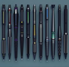 several different types of pens lined up next to each other on a blue surface,