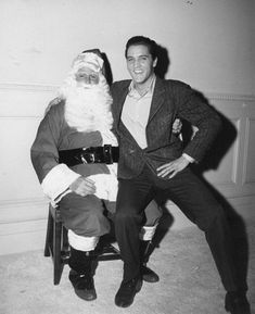 black and white photograph of man in suit with santa clause