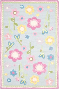 a blue rug with flowers on it and pink trim around the edges, in front of a light blue background