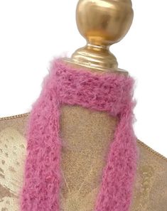 a pink scarf on top of a mannequin