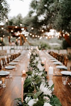 a long table with candles and flowers on it