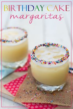 two glasses filled with cake margaritas on top of a table