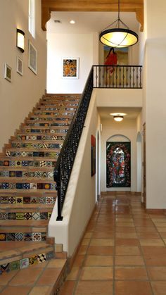 an entry way with stairs and tiled floors