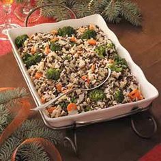 a casserole dish with broccoli, rice and carrots