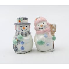 two ceramic snowmen with hats and scarves