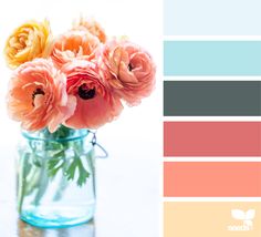 a vase filled with flowers sitting on top of a table next to color swatches