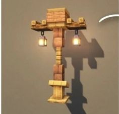 a wooden cross with two lights hanging from it