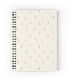 a white notebook with pink flowers on it