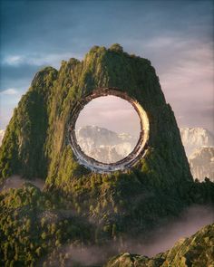 an aerial view of a mountain with a circular hole in the middle that is surrounded by trees and bushes