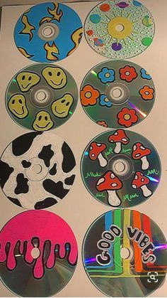 several cd's with different designs on them