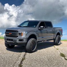 a large gray truck parked on top of a parking lot