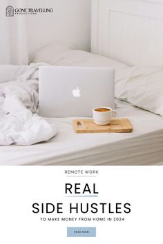 a laptop computer sitting on top of a bed next to a cup of coffee and blanket