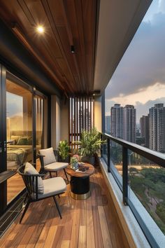 a balcony with two chairs and a table on the wooden floor next to large windows