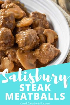 a white bowl filled with meatballs covered in gravy on top of a table