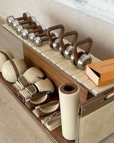 an assortment of shoes and accessories are arranged on a shelf in the middle of a room