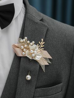 a man wearing a suit and bow tie with a boutonniere on his lapel