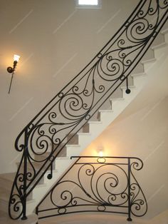 an iron stair railing with lights on the side