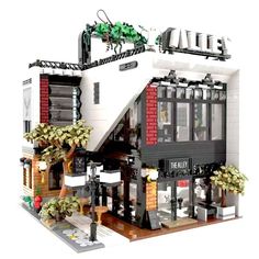 a building made out of legos is shown in front of the sign for an eatery