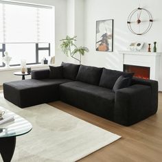 a living room filled with furniture and a fire place next to a large glass window