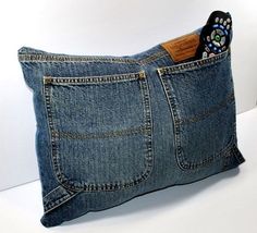 a pillow made out of jeans with a remote control in it's back pocket