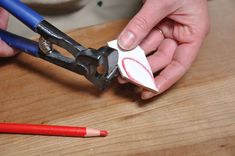 a person cutting paper with a pair of scissors