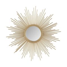 a gold sun mirror on a white wall