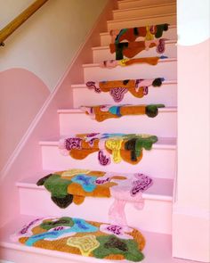 there is a set of stairs decorated with colorful rugs on the bottom and bottom