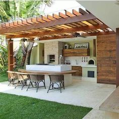 an outdoor kitchen and dining area is shown