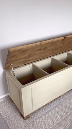 a wooden bench with four compartments on the bottom and one section open to show what's inside