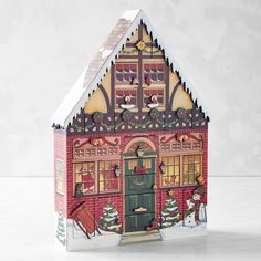 a paper house with christmas decorations on it