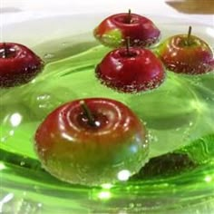 green glass plate with red apples on it