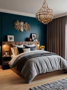 a bedroom with teal walls and wooden flooring is pictured in this image, the bed has a gray comforter on it