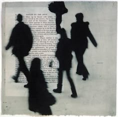 silhouettes of people walking in front of an open book