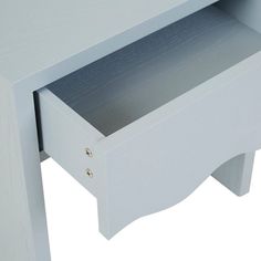 a close up of a white table with an open drawer on the top and bottom