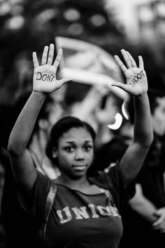 a woman holding her hands up with the word don't written on them