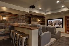 this is an image of a home theater with seating and bar in the living room