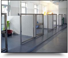 an empty room with metal partitions on the floor and windows in the wall behind them