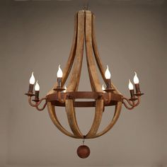 a wooden chandelier with six lights hanging from it's center, in an antique style