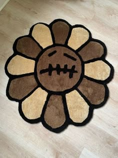 a brown and black flower shaped rug on the floor