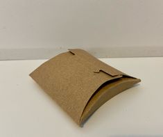 a brown paper bag sitting on top of a white table