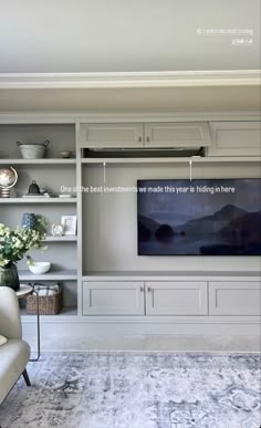 a living room filled with furniture and a flat screen tv mounted to the wall above it