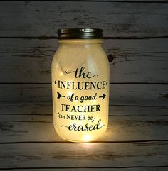 a lighted mason jar with the words, the influence of a good teacher can never be passed