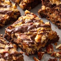 there are many pieces of chocolate and nuts on this cookie sheet that is cut in half