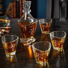 four glasses and a decanter on a table