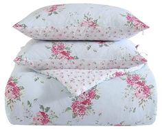 three pillows stacked on top of each other with pink and white floral designs in them