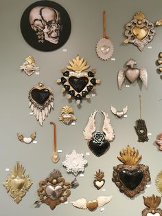 there are many heart shaped brooches on the wall