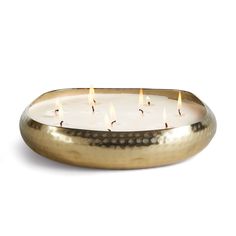 a brass candle holder with five lit candles in the center and two on each side