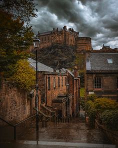 an image of a city street scene with storm clouds in the background