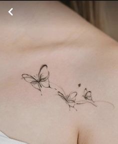 a woman's chest with two butterflies on it